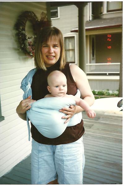 Baby in a sling style carrier.