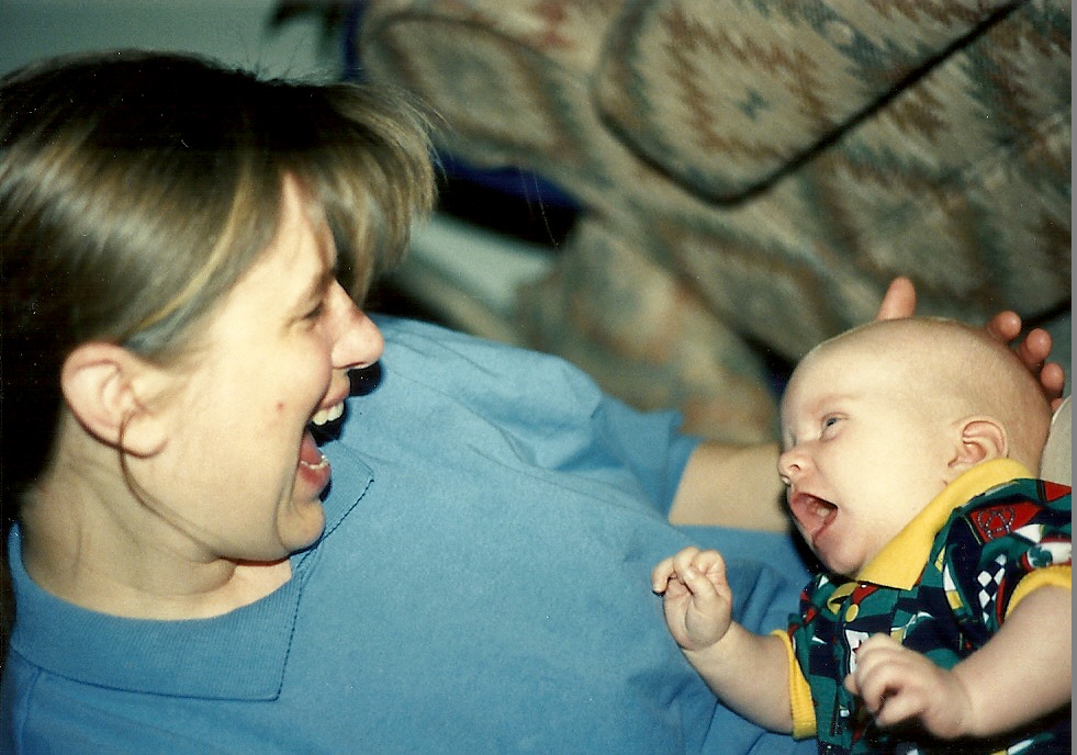 Baby imitates mother.